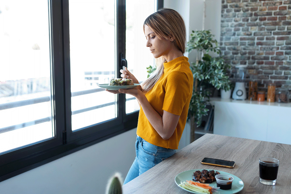 Woman practicing Hara Hachi Bu and mindful eating at home