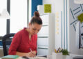 Woman organizing her desk as a grounding reset practice