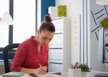 Woman organizing her desk as a grounding reset practice